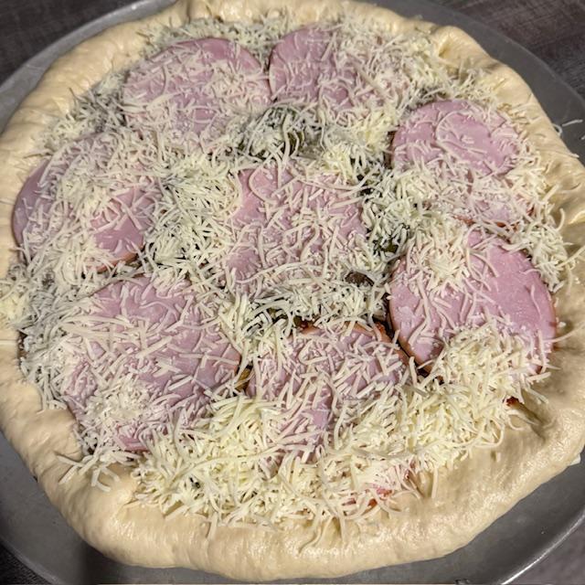 My pizza before baking. Cheese in the crust folded over, added sauce, first layer of cheese, onion, pepper, mushroom, beef, Candadian bacon, jalapeno, & 5 blend cheese on top.