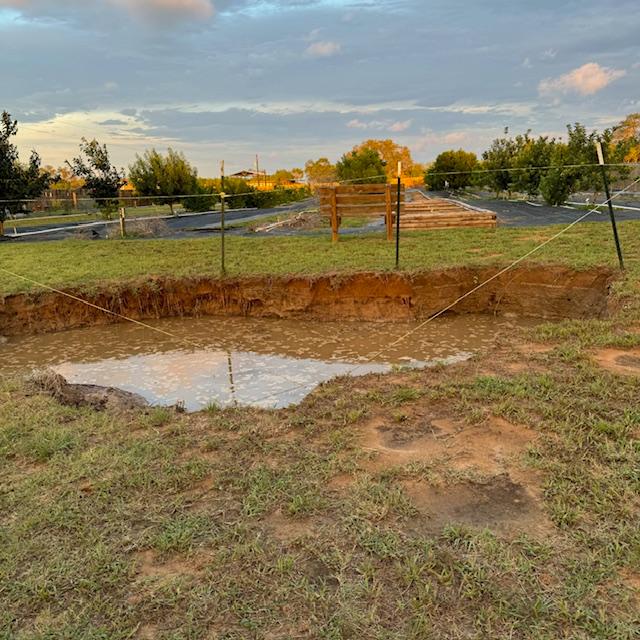 This was supposed to be a second pond but the hole is not big enough yet. It is full of water after the rain. This was supposed to be a second pond but the hole is not big enough yet. It is full of water after the rain.