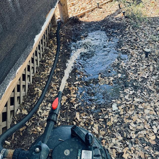 Cleaning the pond. The water is shooting out like it should.