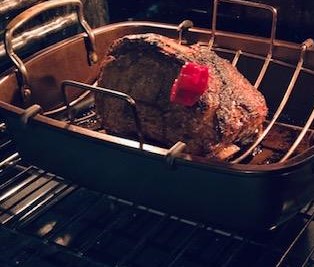 The prime rib is ready! The red thing in the meat is the meat thermometer, not raw meat. LOL!