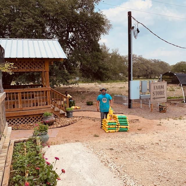Nacho and his helper are putting the planters together out by the gazebo.