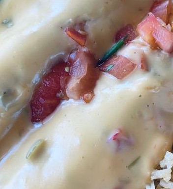 Queso over some enchiladas. Absolutely delicious.