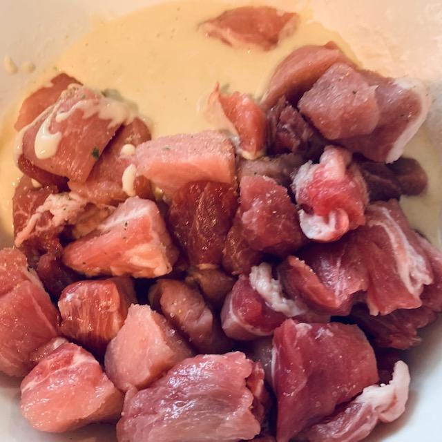 Raw meat being stirred into batter.