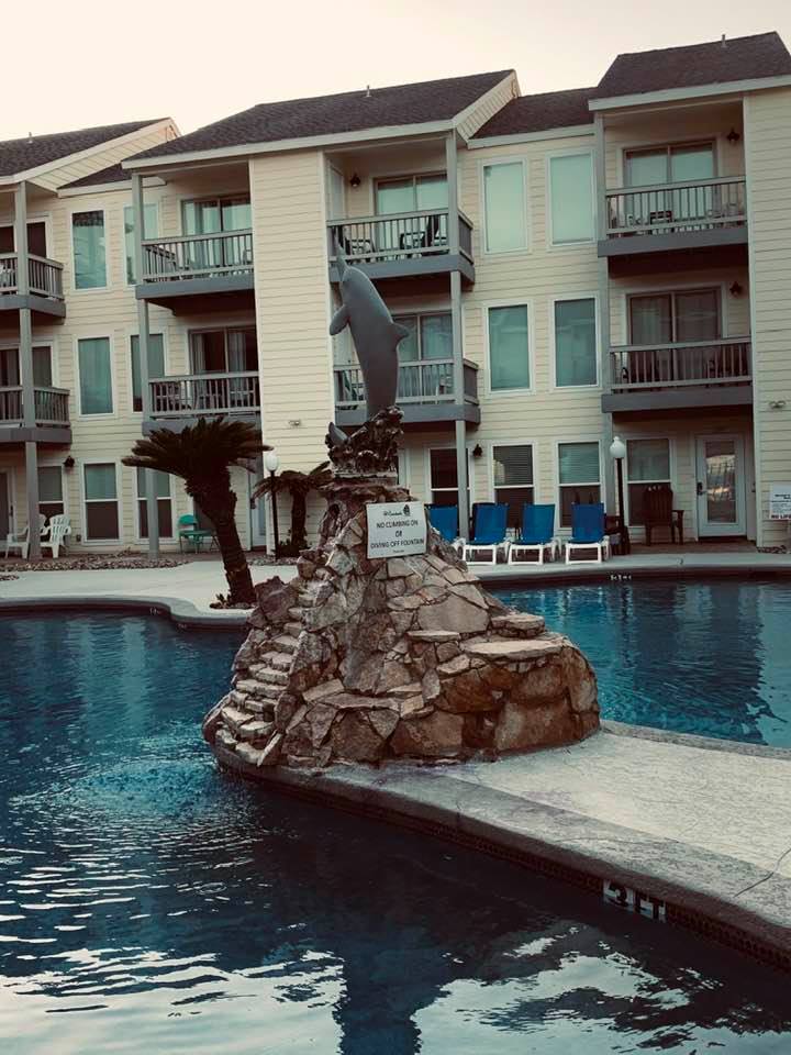 The resort pool has a dolphin fountain in the middle and is heated.