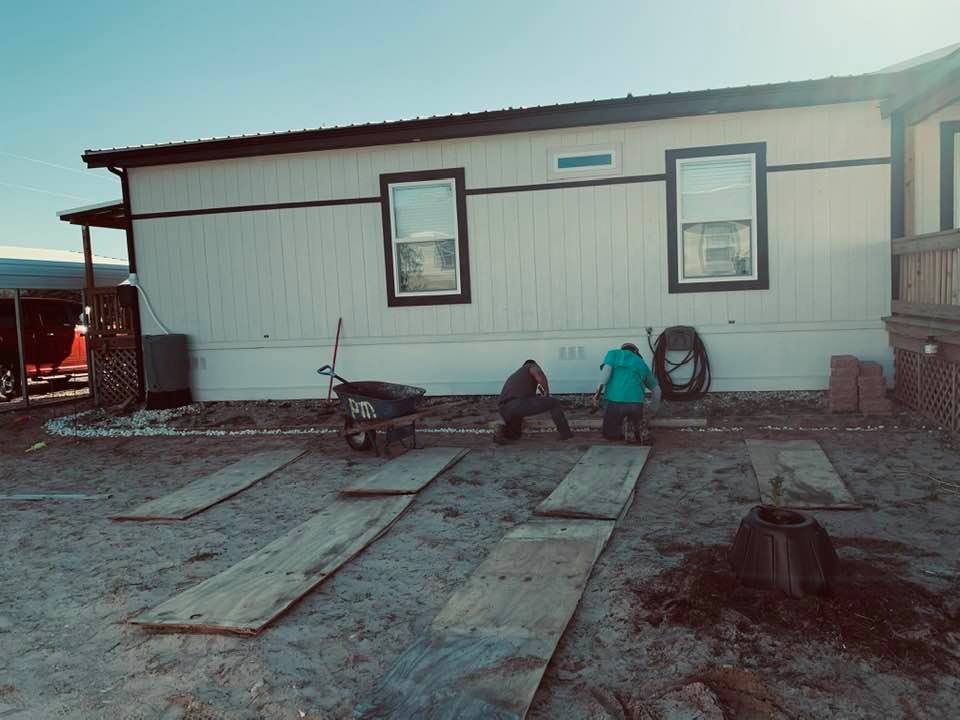 Nacho and Ryan built a retaining wall in the front of our home, curving around to the side porch.