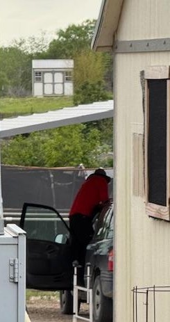 The Safelite man is in my driveway replacing the windshield on my car. I was over in the gazebo feeding the fish when I took this.