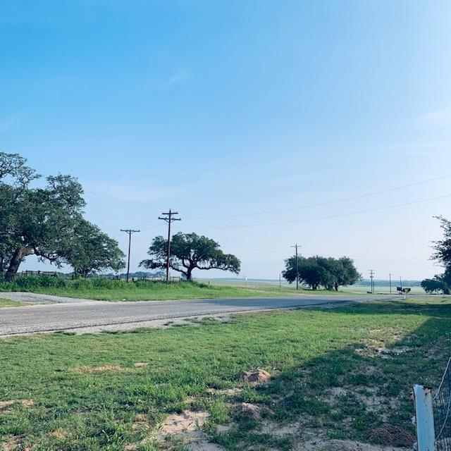 Straight ahead there is the grass farm and then behind it, the sand mine. Trucks from it pass all day and night. This view is from our gazebo and pond.