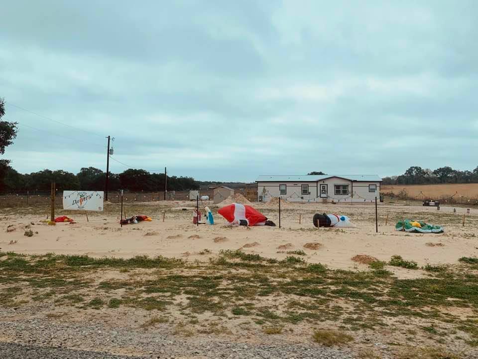 The front of our home with the blowups dancing in the wind. Santa looks like he is doing push ups.