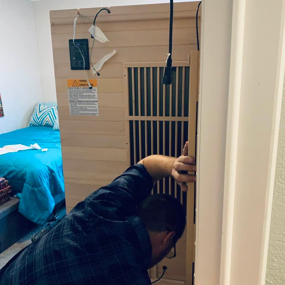 Matt and Aaron are in the guestroom putting the huge sauna together.