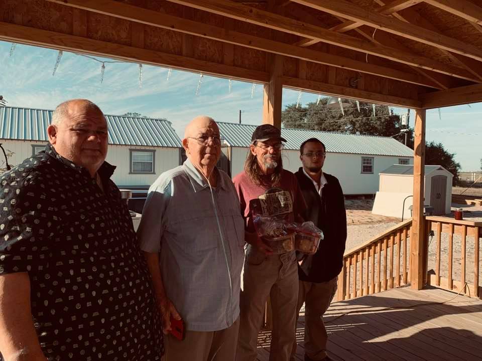 David, John Sr., Gene, and our son Matthew on our front porch with our business buildings behind them.