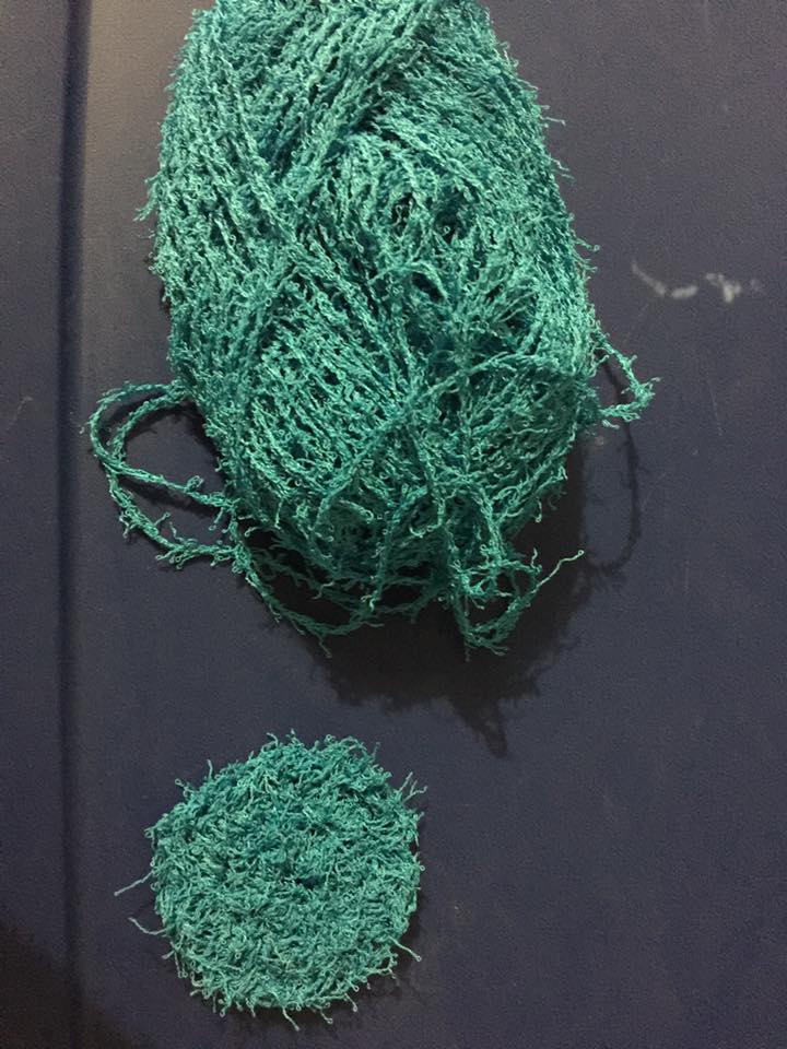 Scrubby yarn is textured to clean dishes, pots, and pans but it is very hard to work with. The first scrubby I crocheted is the round thing at the bottom. The holes are very difficult to see.