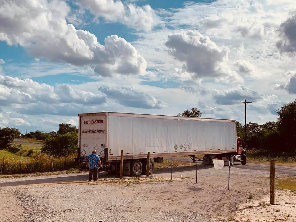 David is directing the driver to help him get the semi inside of our fence.
