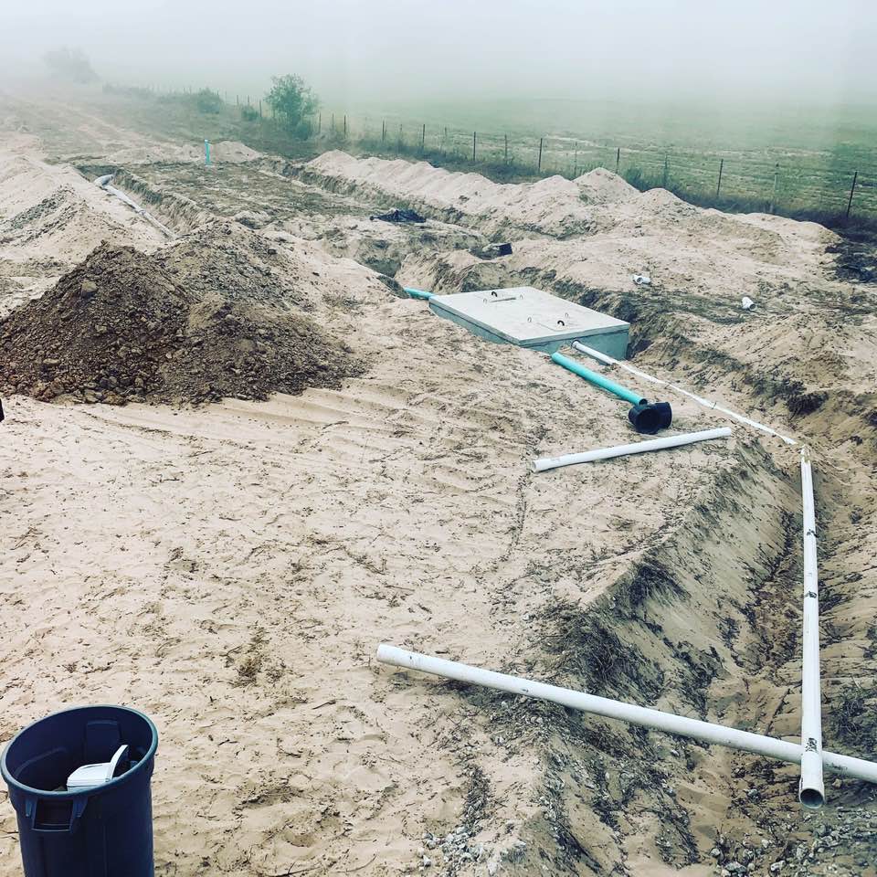 This is what our yard looked like after the septic tank was installed. They left it like this overnight so it could be inspected the next day.