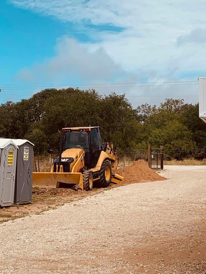 Digging the hole for the business septic tank for building #4. Don't the port a potties look so lovely in the yard? I can't wait until they are gone and we have real bathrooms.