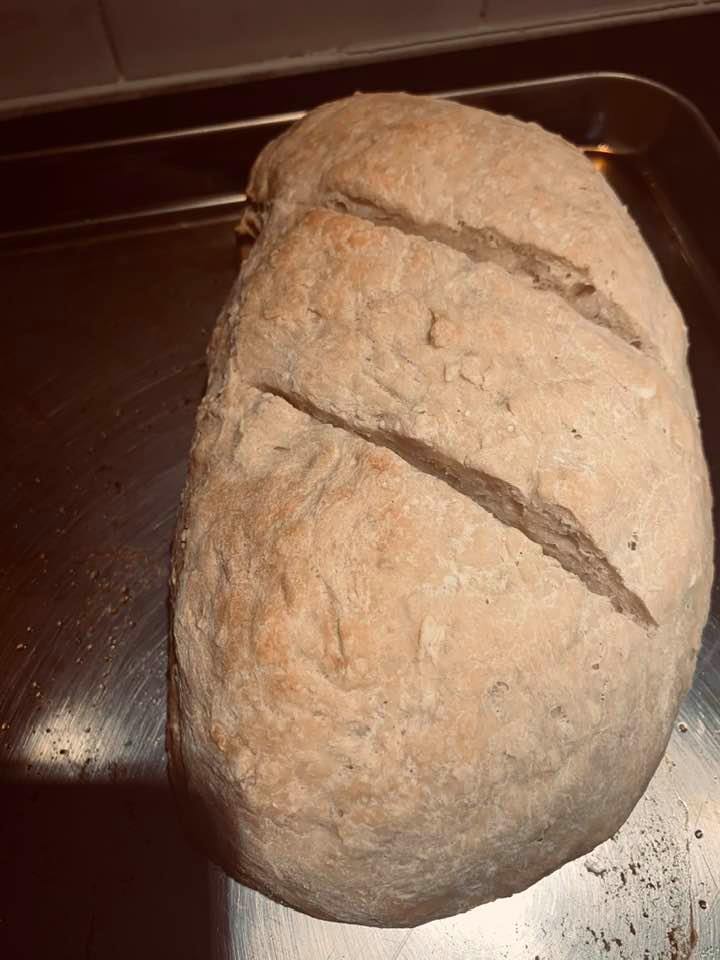 A baked loaf of sourdough bread fresh out of my oven. Start homesteading in your kitchen.