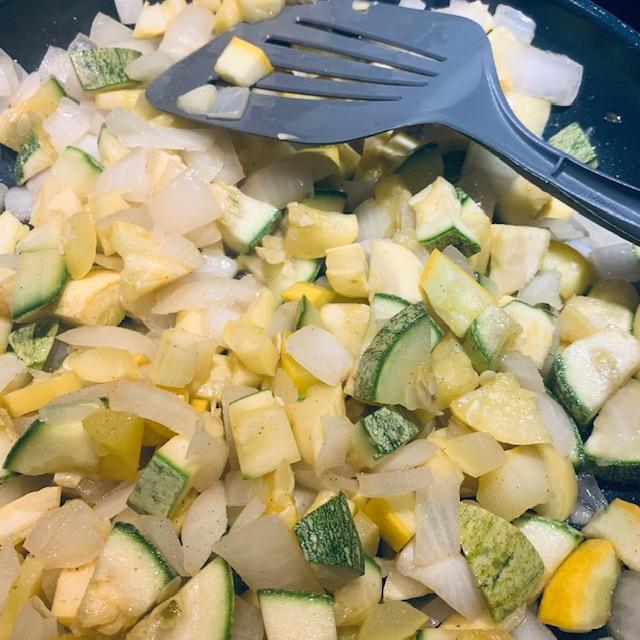 Cooking up some squash with onions in the summer.