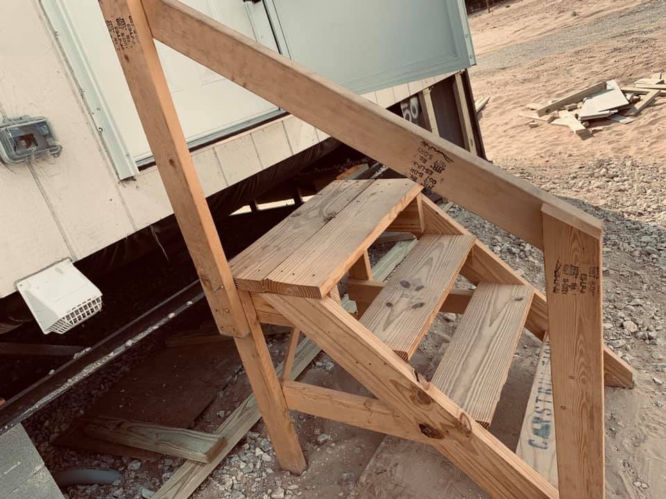 The construction stairs need mobile home repair. They wobble and are full of splinters. And don't they look lovely with our new home? The construction stairs need mobile home repair. They wobble and are full of splinters. And don't they look lovely with our new home?