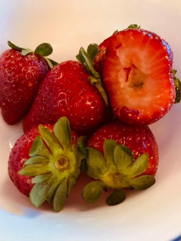 You want to cut the green caps off so the leaves are not in your berries when you eat them.