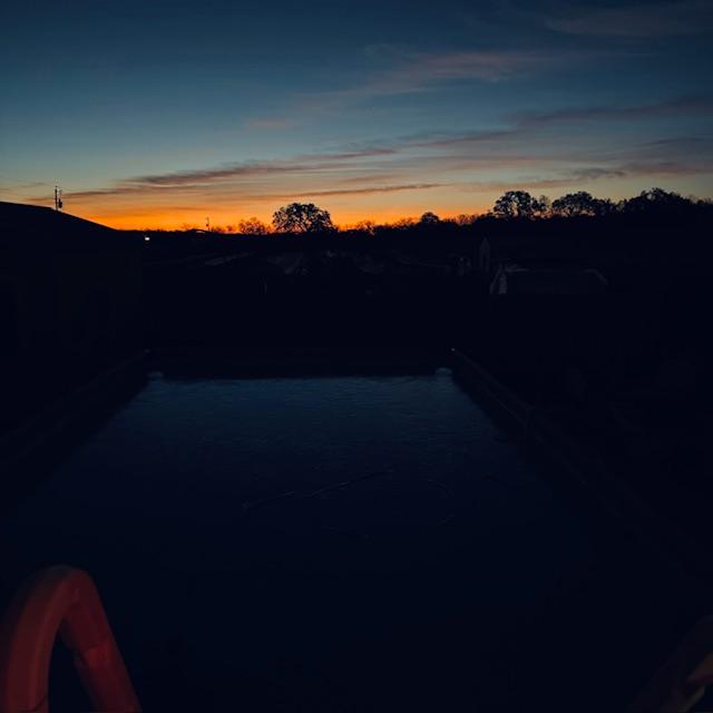 I was outside with Ethel, freezing when the sun was coming up. The pool has a layer of ice on it.