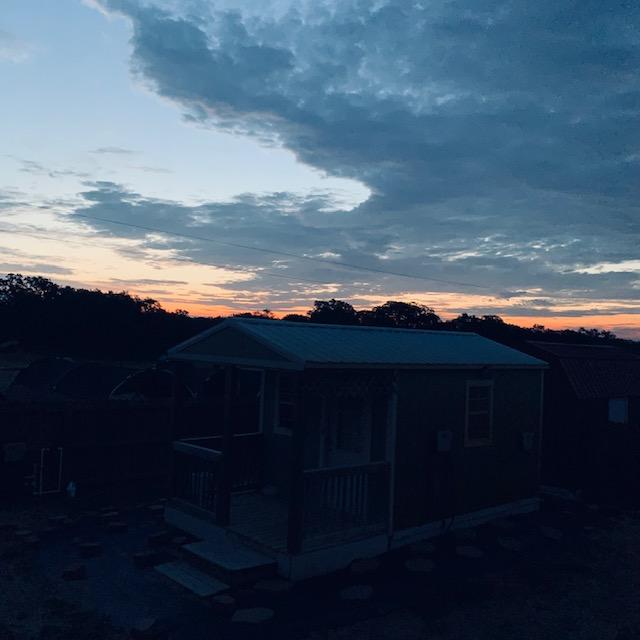 Foghorn crows in the background as the sun begins its ascent for a new day over the little green shack where we lived for over 3 weeks in the August heat.