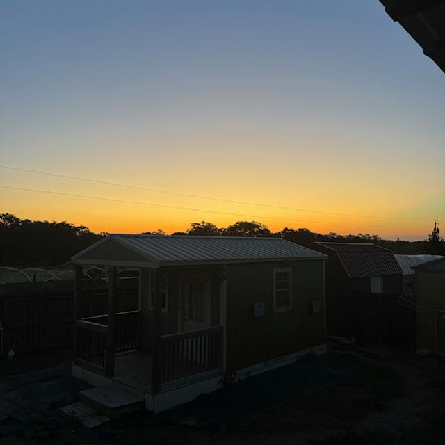 The sun rises over our first little home out here, the shed/shack where we spent over 3 weeks while they dillied and dallied getting our house all together. The sun rises over our first little home out here, the shed/shack where we spent over 3 weeks while they dillied and dallied getting our house all together.