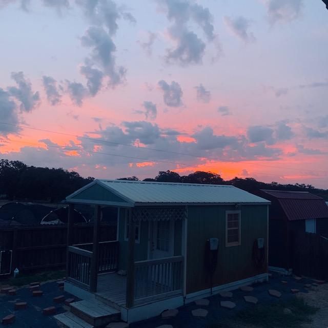 Here comes the sun right over the green shed shack where we once lived for almost a month out here on our farm.