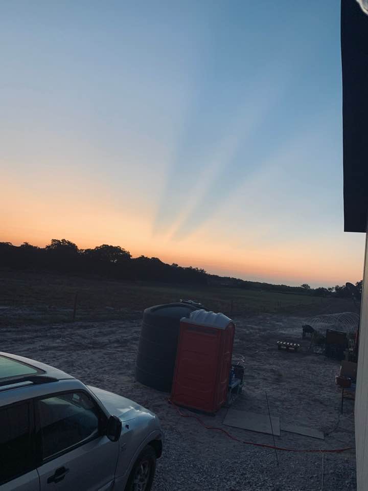 Sunrise on the farm with the portable potty and the water tank. #reallife