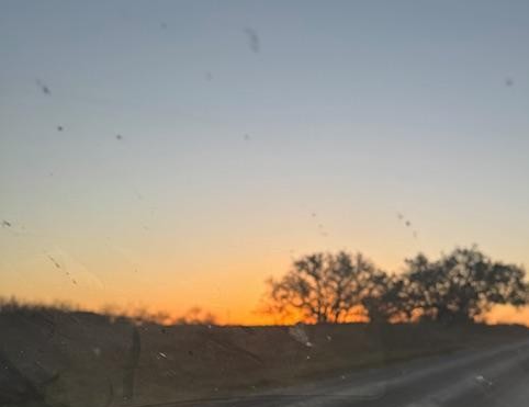 Sunrise through a dirty windshield as we drove to the doctor's office down the road from our farm.