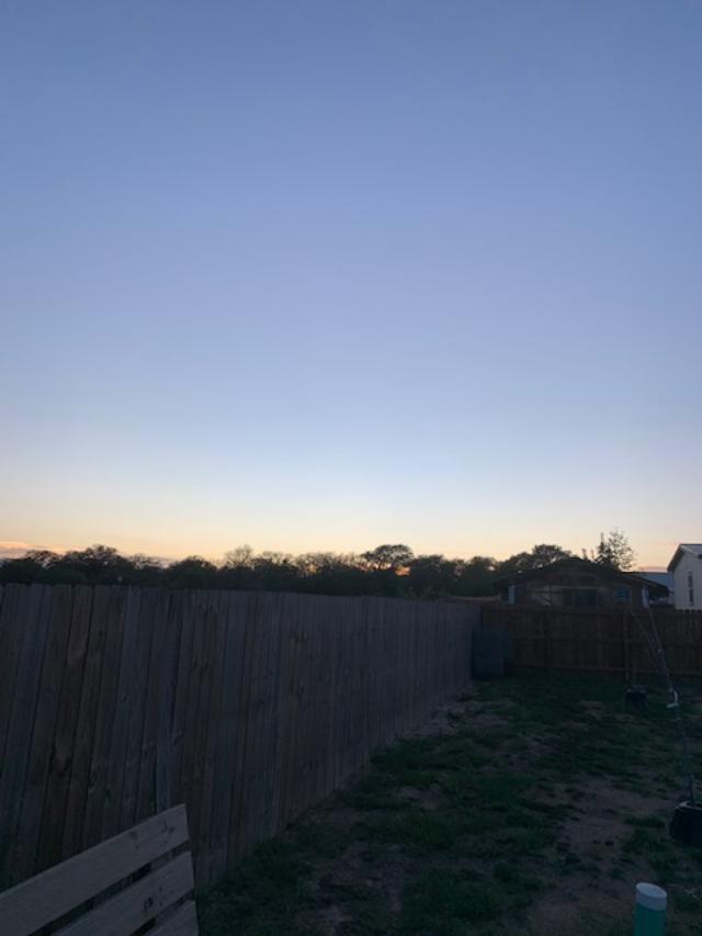 Twilight after the sun has set. I was a bit late putting the chickens away tonight. You can see the bench by the chicken coop.