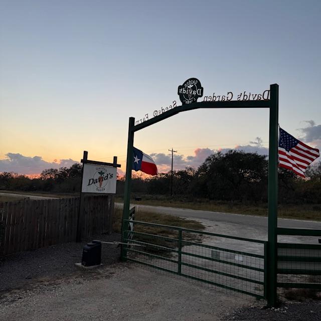 The sun is setting over our gate with our brand new flags. Flags don't last long in all of the wind we have here.