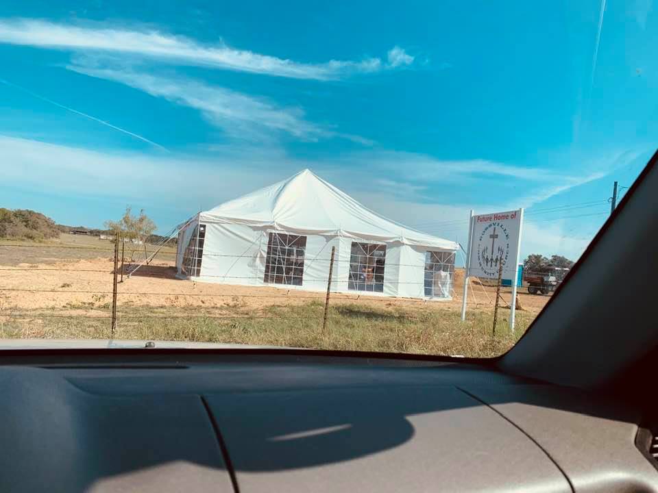 The tent church. This photo was taken inside our SUV where we parked.