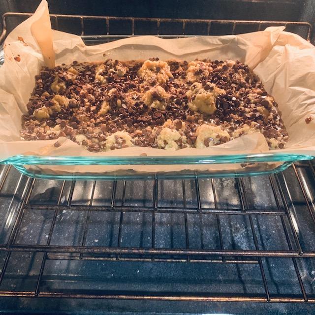 Baking the bars. Using parchment paper really helps with clean up. That stuff is amazing!