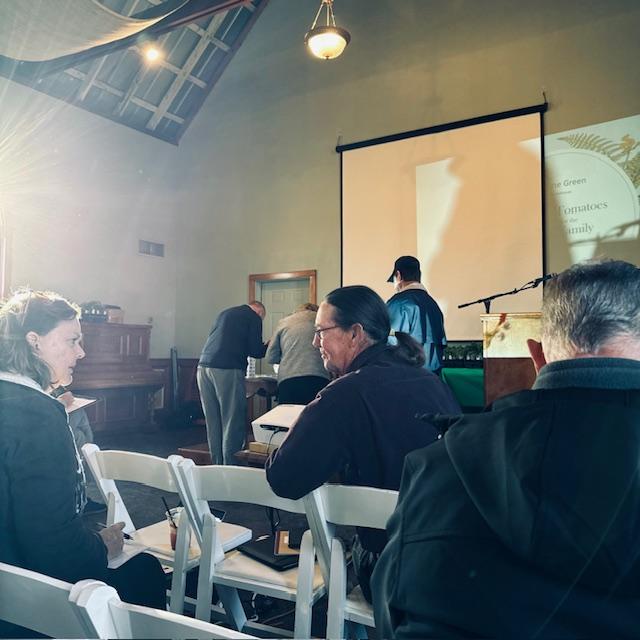 Once we set up the table, we sat down in the audience. Soon the place we packed in.