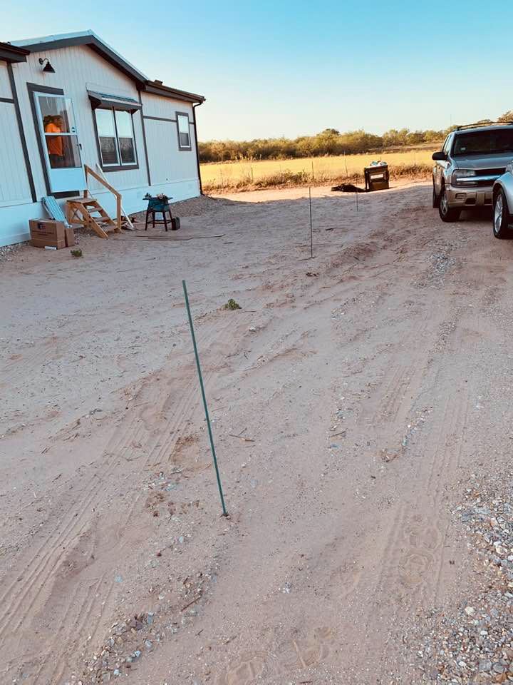 David put ten stakes in front and along the sides of the house for the trees to be planted. Note the wobbly stairs given to us to enter our home.