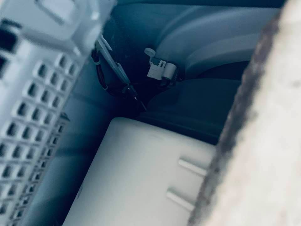 The white button had to be pushed inside the washer so the door would open.