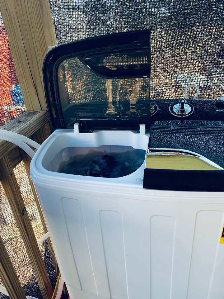 This is the mini washing machine on the porch. It is so small that we have it standing on an ice chest.