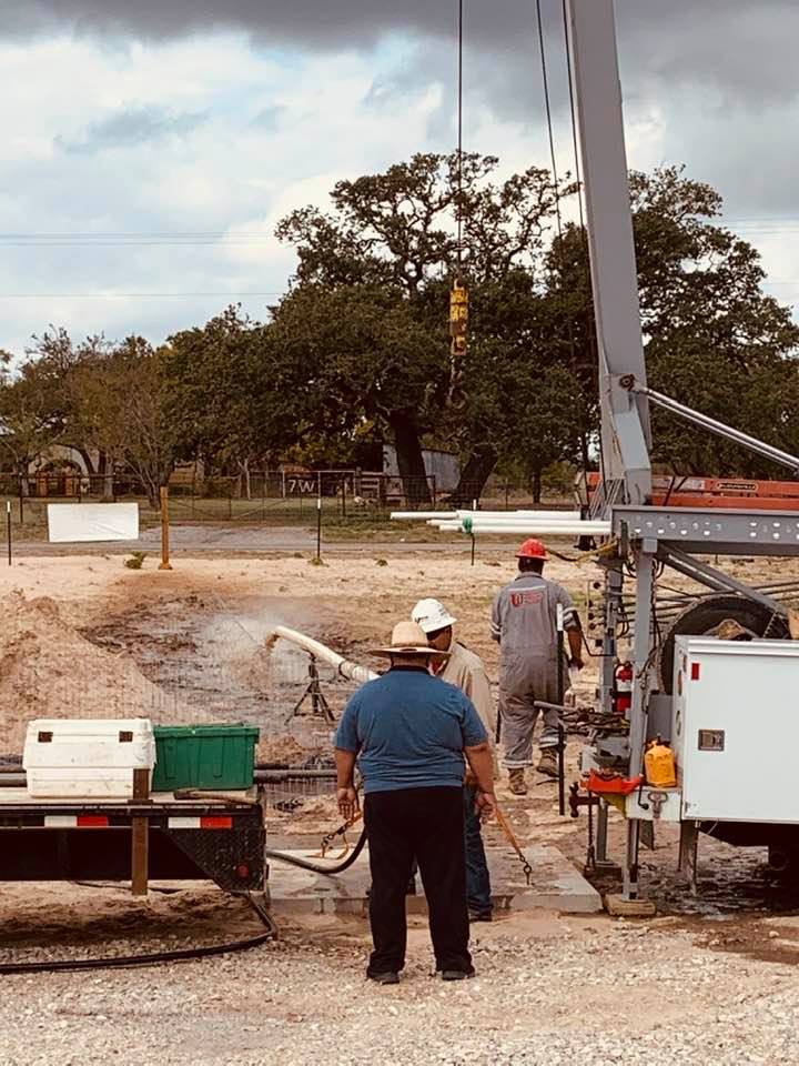 The well company now has water spraying out of the well. It is full of sand. It will have to flow out like this until it runs clear.