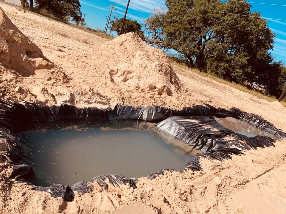 Six foot deep pit with water and sand from up to 380 feet under the ground.