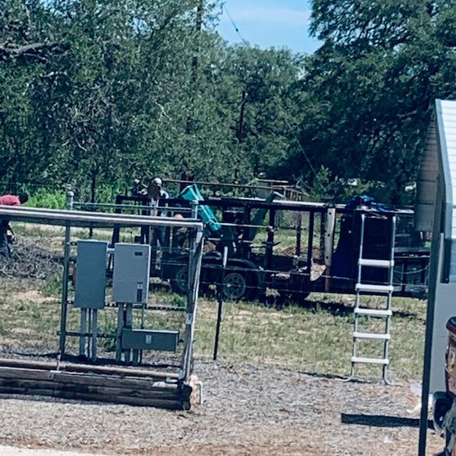 Our wood chipper was taken to the neighbor yard to chip wood. Then it was brought back for next time.