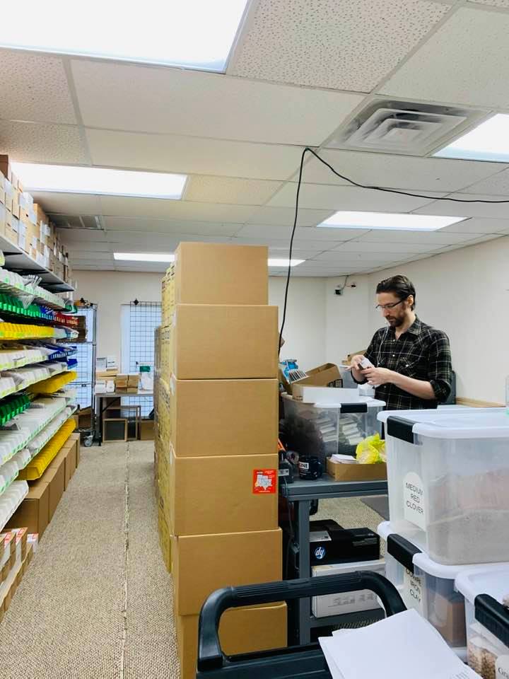 One of our temporary workers stuffing seed envelopes. In just over 3 months, we would shut this office and move it to the farm.