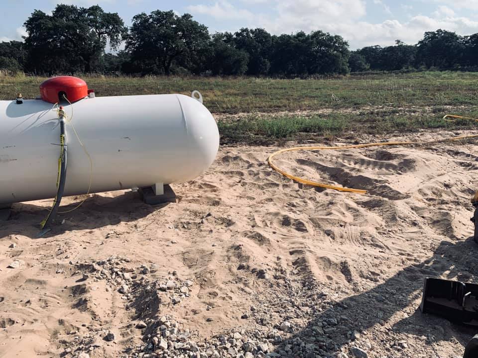 The yellow gas line is now in the sand next to the propane tank.