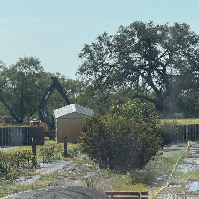 They just took the back gate off and left it in this photo. Now they will drag it to the end of the fence, swing over to the new property and zoom through it to the road.